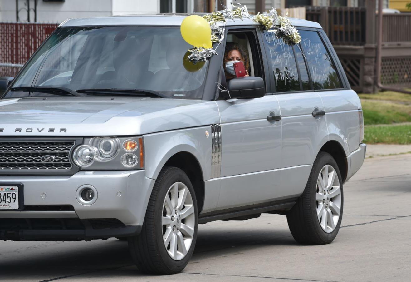 A woman films the Kirbys' smiles from the safety of her vehicle